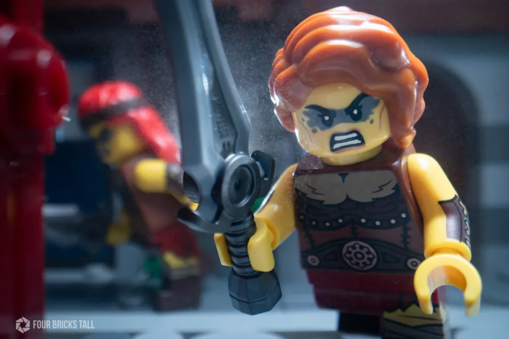 LEGO barbarian charging at a door to raid the home.
