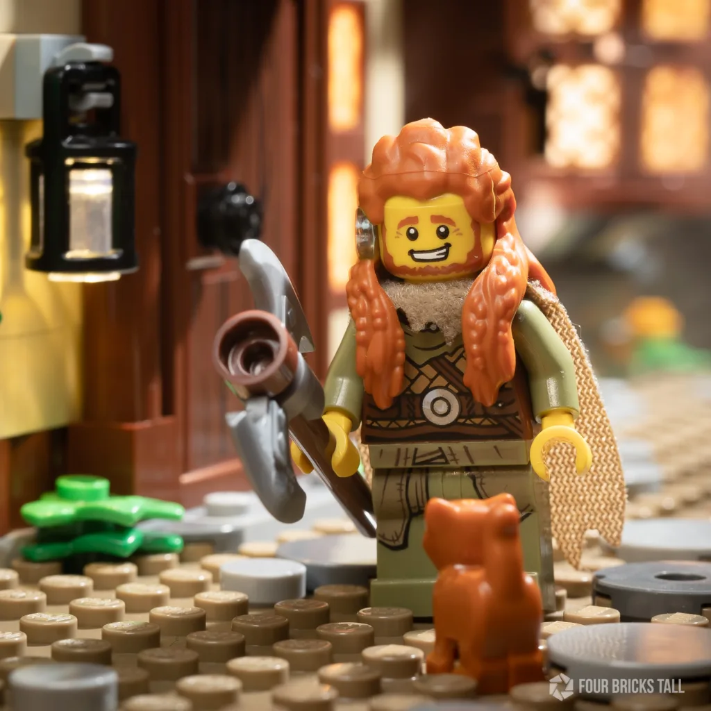 Viking minifigure with a mix of LEGO parts looking at a kitten
